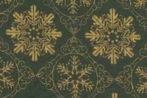 Cajas de álbumes navideños con diseño decorativo dorado y verde.